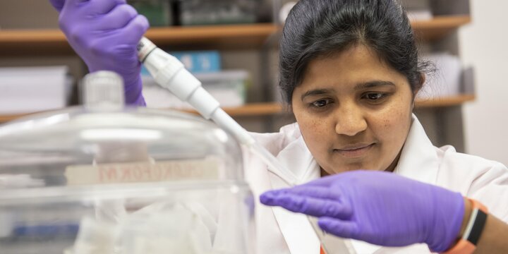 Student working with a pipette in a lab