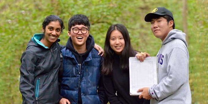 NRES students holding paper and smiling