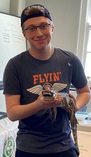 AJ Studer holding an alligator